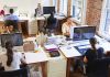 Open plan office with people working at desks