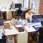 Open plan office with people working at desks