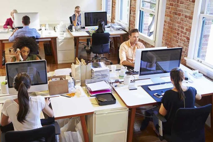 Open plan office with people working at desks