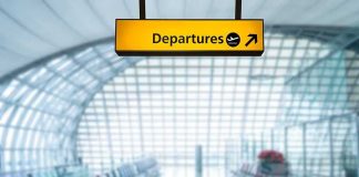 Tennessee Moves to Rename Nashville Airport Departures sign hanging in a modern airport terminal