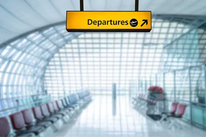 Departures sign hanging in a modern airport terminal
