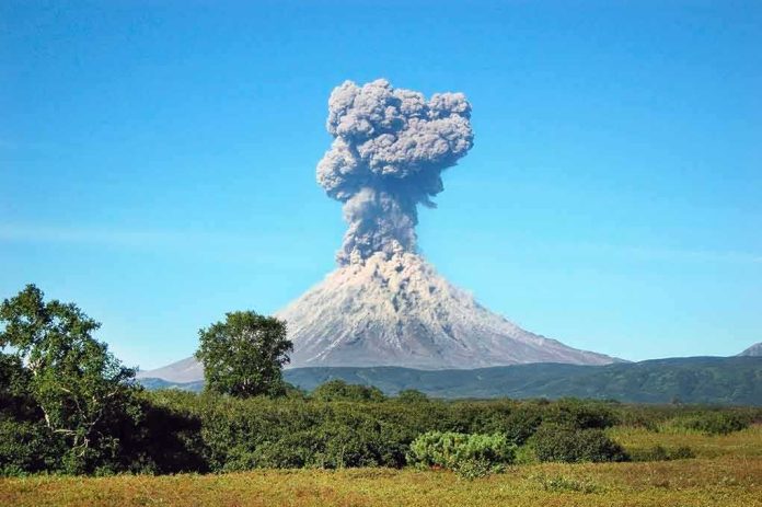 shutterstock_468722087 Volcano erupting with a towering ash plume
