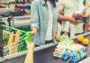 Customer paying with a card at a supermarket checkout