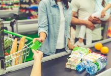 Customer paying with a card at a supermarket checkout