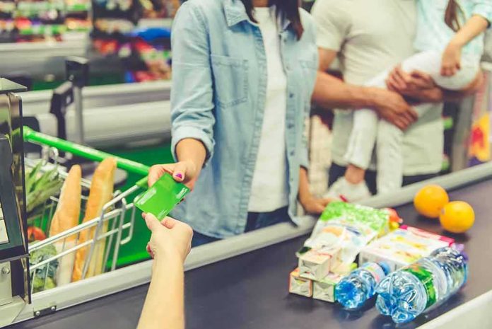 Customer paying with a card at a supermarket checkout