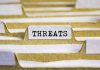 index tab labeled threats in a filing organizer