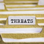 index tab labeled threats in a filing organizer