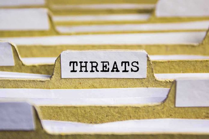 shutterstock_525112936-1 index tab labeled threats in a filing organizer