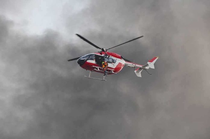 shutterstock_554743687 Rescue helicopter hovers amid thick smoke