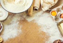 Baking ingredients on a floured wooden surface