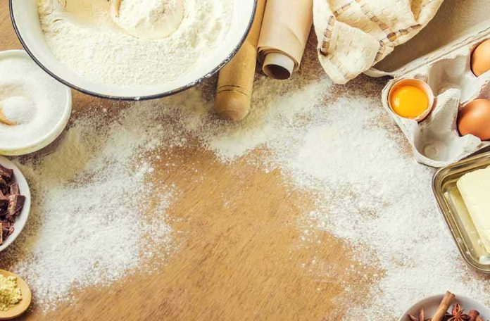Baking ingredients on a floured wooden surface