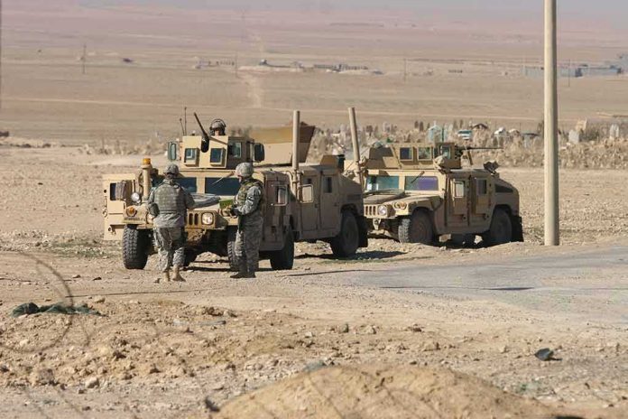 Soldiers near armored vehicles in a desert