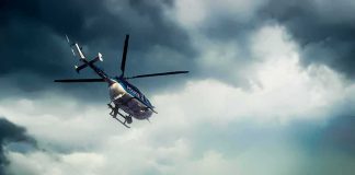 Police Chopper Hit — What Went Wrong? Police helicopter flying under dark storm clouds