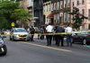 Police gathered at an urban crime scene.