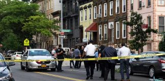 Woman Arrested in Brooklyn Child Case Police gathered at an urban crime scene.