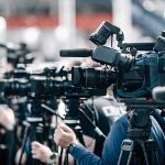 Sinkhole in Malibu Swallows Cage’s Driveway Broadcast cameras on tripods at a press event