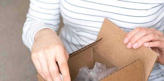hands opening a cardboard box
