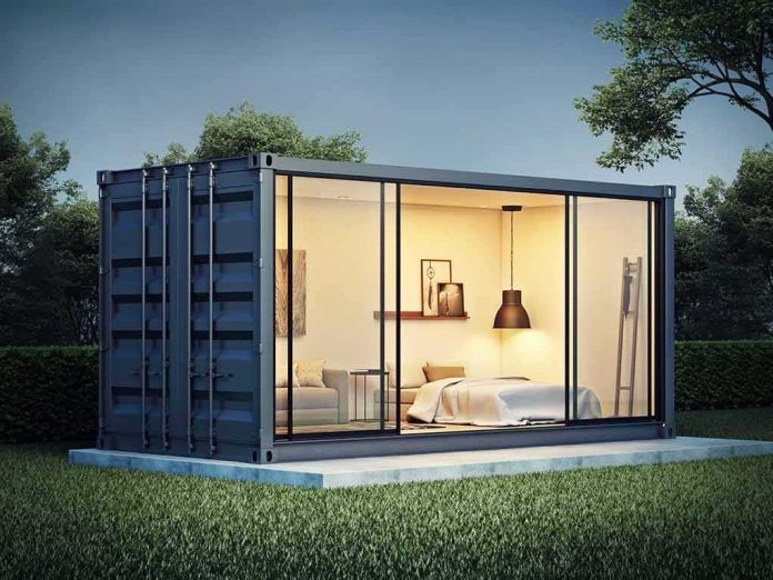 shipping container home with glass walls at dusk