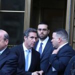 DHS Graphic Sparks RACISM Firestorm group of men in suits leaving a courthouse entrance