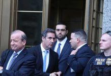 group of men in suits leaving a courthouse entrance