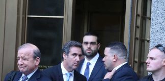 group of men in suits leaving a courthouse entrance