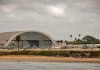 airport hangar with helicopters near a shoreline