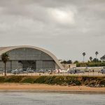 Gulf Bases Show Visible Damage airport hangar with helicopters near a shoreline