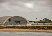 airport hangar with helicopters near a shoreline