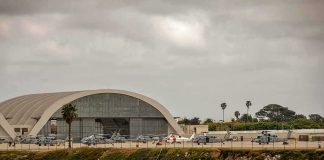 Gulf Bases Show Visible Damage airport hangar with helicopters near a shoreline