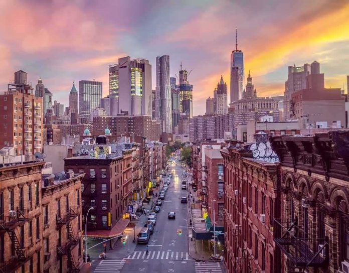 shutterstock_1093445573 City street leading to a modern skyline at sunset