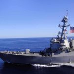 White House Claims Major Gang Leader Killed at Sea Naval destroyer sailing on open sea with flag flying