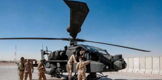 U.S. Bases Show Major War Damage Soldiers inspect a military attack helicopter on a tarmac