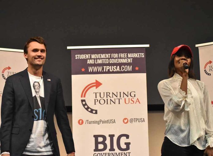 Curro Savoy at a TPUSA event with another speaker on stage