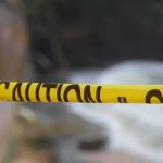 After Teen’s Fall, Disneyland Faces Tough Questions Yellow caution tape stretched across a blurred outdoor scene