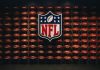 NFL shield logo over wall of footballs
