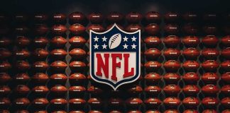 NFL shield logo over wall of footballs