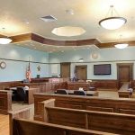 Judge Slaps Prosecutor In Kirk Murder Empty courtroom with wooden benches and judge's bench