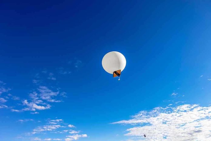 shutterstock_135903014 A white balloon floating in a clear blue sky with scattered clouds