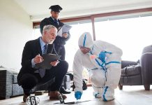 Forensic investigator collects evidence as police and detective observe