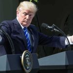 Citizenship Fight Heats Up After Calls for Deportation Donald Trump speaking at dual podiums with arms outstretched