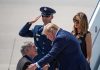 Donald Trump greets Greg Abbott as Melania Trump and Daryl Harper look on at an airport
