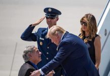 Donald Trump greets Greg Abbott as Melania Trump and Daryl Harper look on at an airport