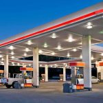 Gas-Station Carnage Stuns LA gas station canopy with multiple fuel pumps at dusk