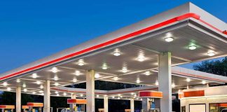 gas station canopy with multiple fuel pumps at dusk