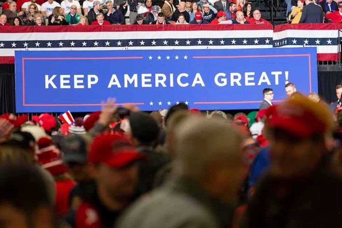 shutterstock_1631143057 Crowd at political rally in front of large Keep America Great sign