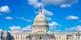 United States Capitol building under a bright blue sky