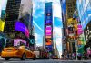 Times Square street with yellow taxi and bright billboards