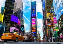Times Square street with yellow taxi and bright billboards