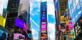 Times Square street with yellow taxi and bright billboards