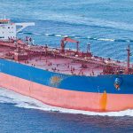 Large cargo ship navigating through the ocean